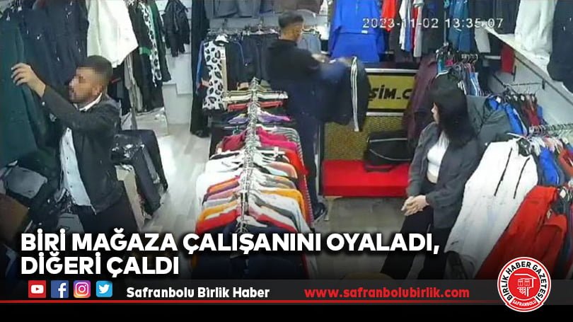 Biri mağaza çalışanını oyaladı, diğeri çaldı